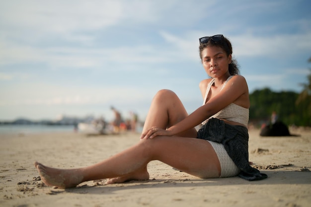 African woman sit on the beach Portrait sexy African lady travel ping and relaxing in the summer with tropical nature