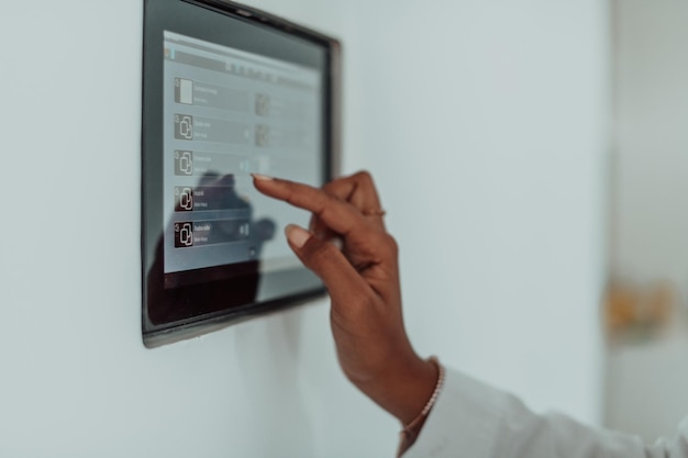 African woman using smart home screen control system