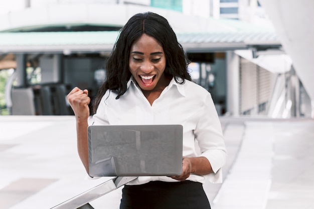 African woman working on laptop