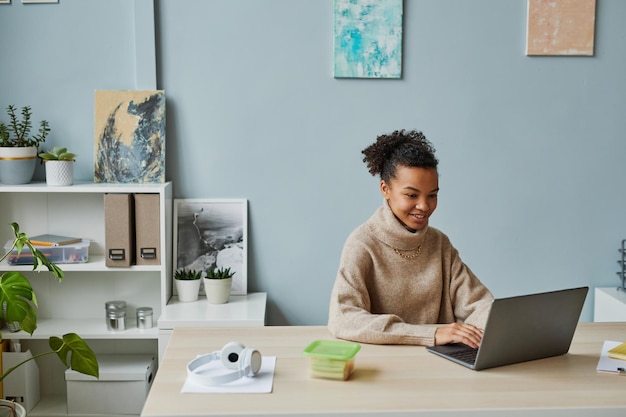 African young businesswoman working on laptop while working at her workplace at office