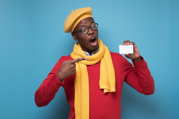 African young man bank manager showing credit card for online shopping