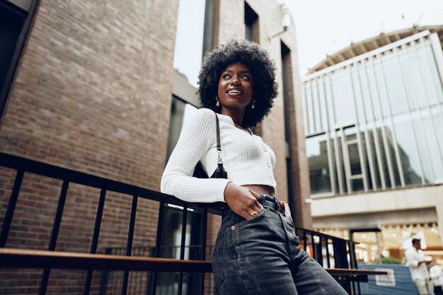 African young woman standing on city street outdoors