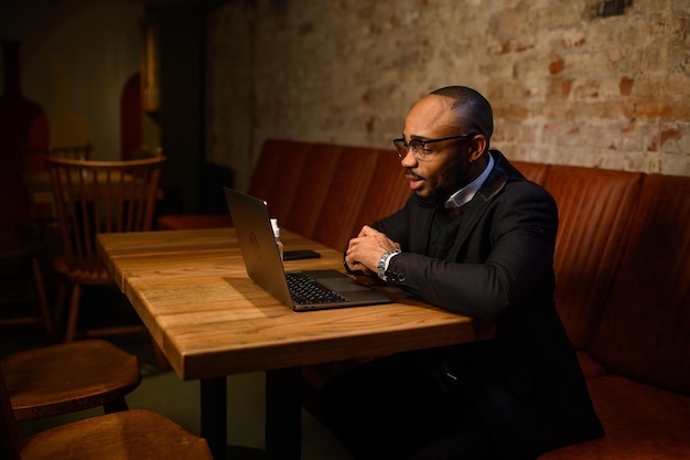 An africanamerican business man in a business suit is talking on a video conference video conference...