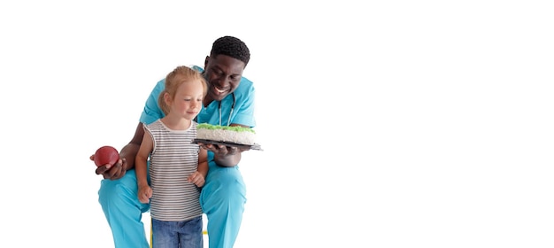 An AfricanAmerican doctor tells a child about the benefits of proper and healthy nutrition