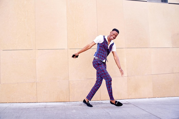 AfricanAmerican man walking funny in a casual plaid suit waistcoat and shortsleeved shirt