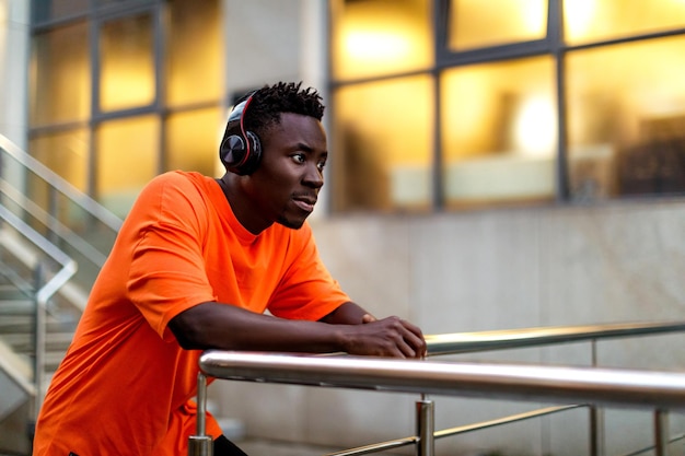 Africanamerican man in wireless headphones listening music