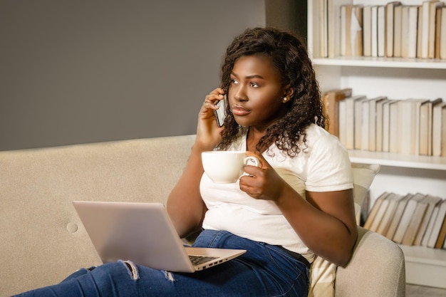 Afro american businesswoman has a coffee break in the meddle of the working day woman sitting on the...