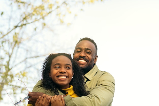 afro american couple smiling and hugging