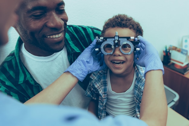 Afro-American Father with Son on Reception Ophthalmologist