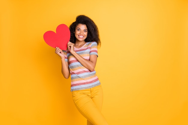 Afro american girl in striped t-shirt hold valentine card heart