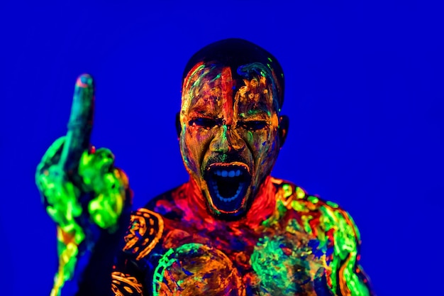 Afro american man with UV body art posing in studio