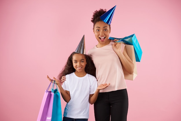 Afro American mother and daughter in holiday caps