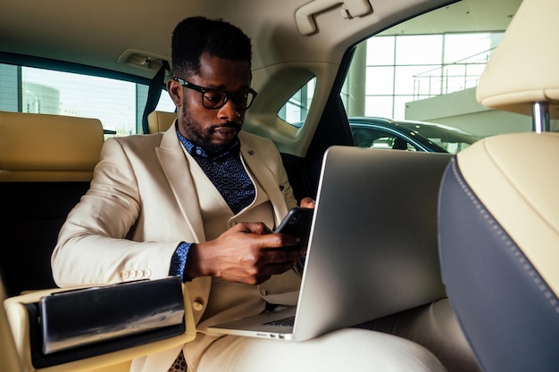 Afro business male talking on phone with smile on face