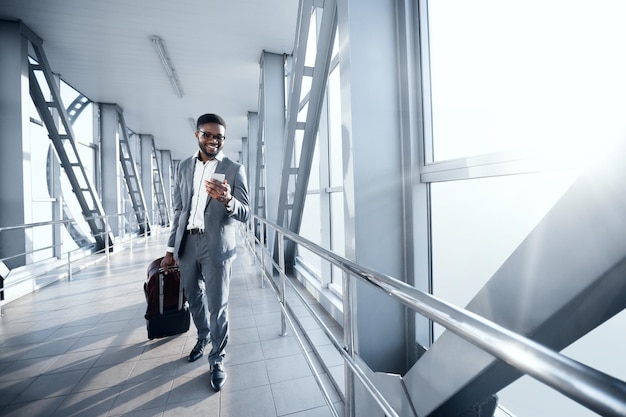 Afro Businessman At Airport Moving To Terminal Gate