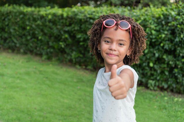 Afro girl standing in the park Casual style