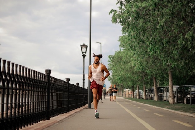 Afro guy jogging in the city