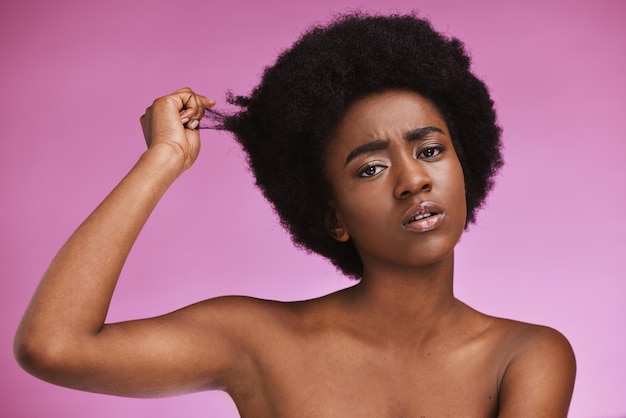 Afro hair portrait and confused black woman in studio for grooming or treatment on purple background Face haircare and girl model unhappy with tangle knot or texture after beauty routine isolated