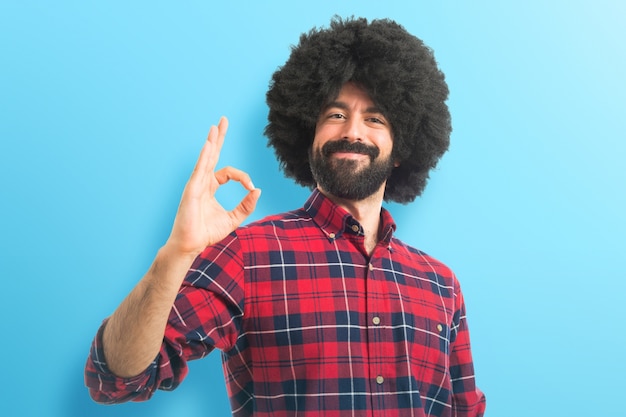 Afro man making OK sign  on colorful background