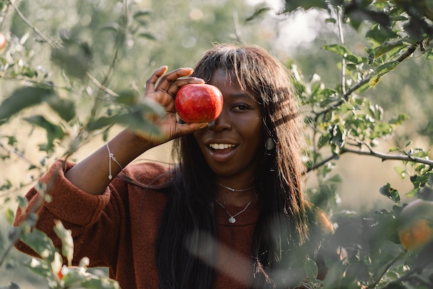 Afro woman in Apple trees orchard