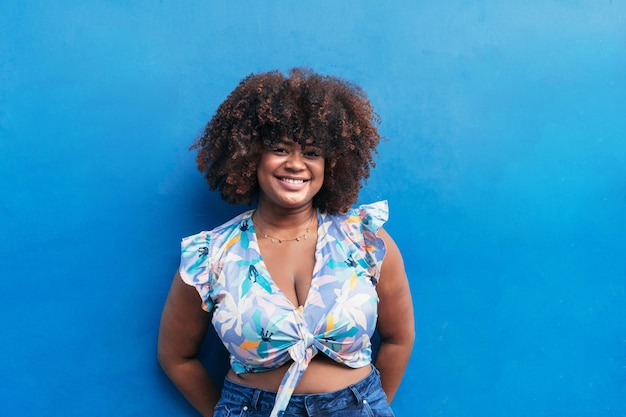 Afro woman on a blue background on a summer39s day