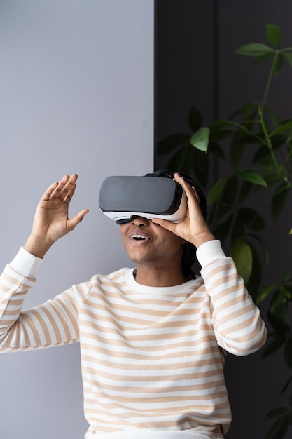 Afro woman play on vr glasses virtual reality and wearable tech female has fun wearing headset