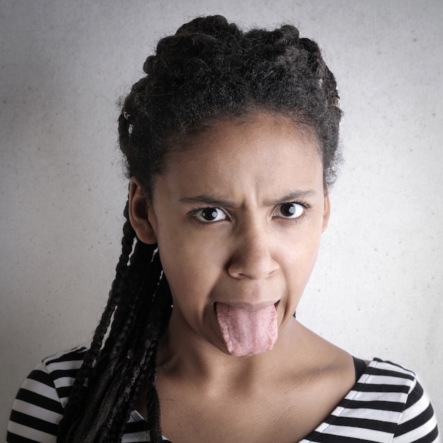 Afro woman showing her tongue