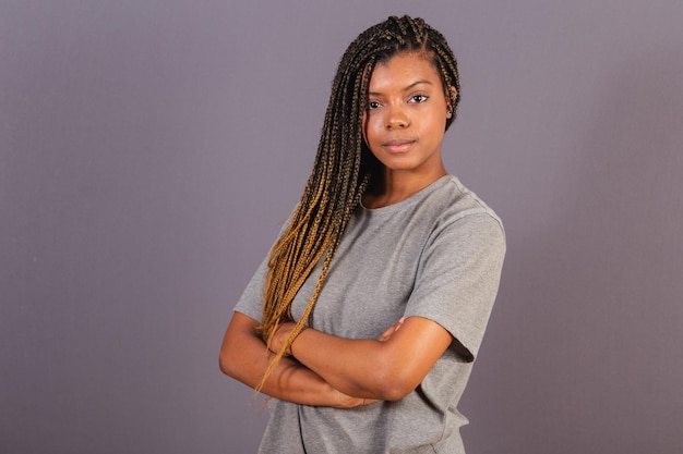 AfroBrazilian young woman arms crossed with a serious look trusting