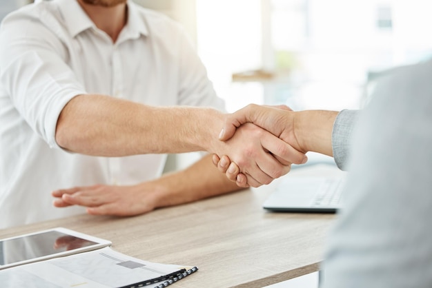 After thorough consultation, they have finally reached an agreement. Closeup shot of two unrecognisable businessmen shaking hands in an office.