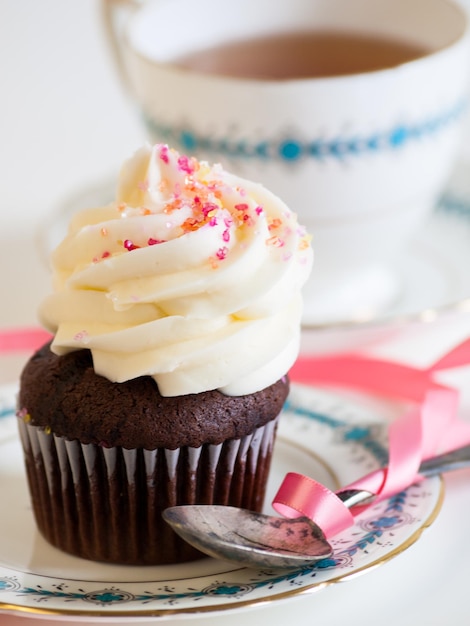 Afternoon tea served with a white cupcake.