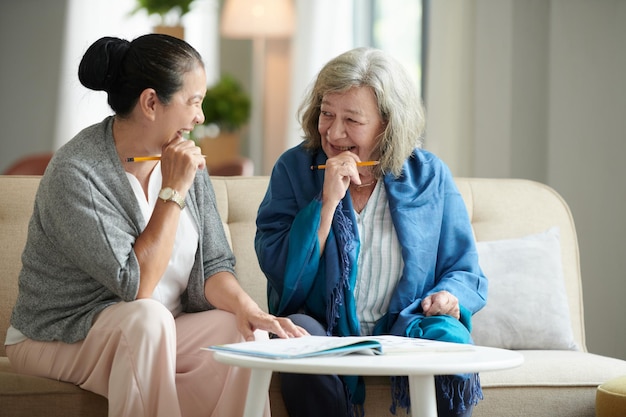 Aged Female Friends Solving Puzzle