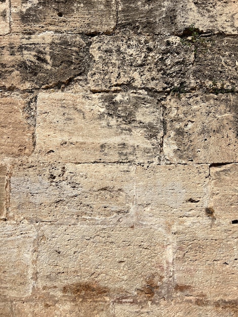 Photo aged stone wall textured surface of an aged stone wall