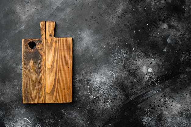 Aged wood cutting board set, top view flat lay , with copy space for text or food, on black dark stone table background