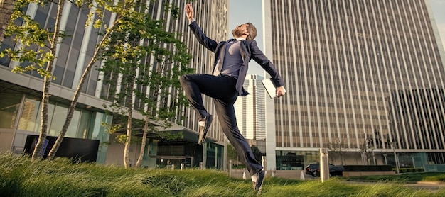 Agile business professional network administrator hold computer boss with modern laptop Man jumping banner with copy space