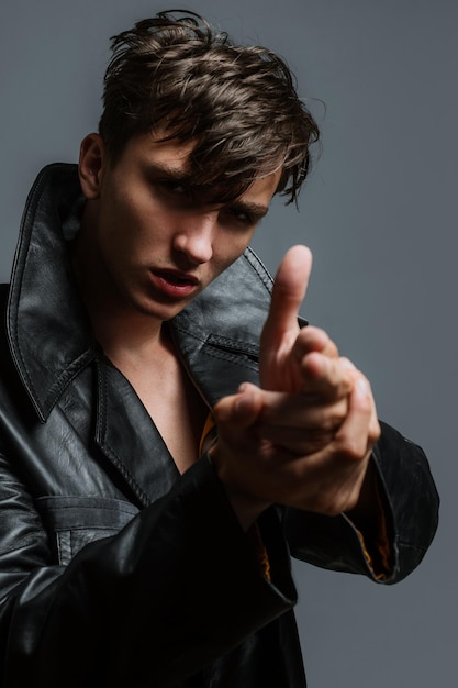 Agressive handsome man with finger gun gesture portrait of fashion style guy