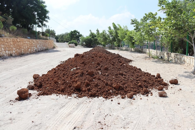 The agricultural soil in the underconstruction garden is being prepared for its use in cultivating