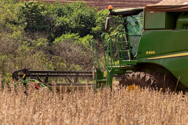 Agricultural tractor harvesting soybeans in the field - Pederneiras-Sao Paulo-Brasil - 03-20-2021.