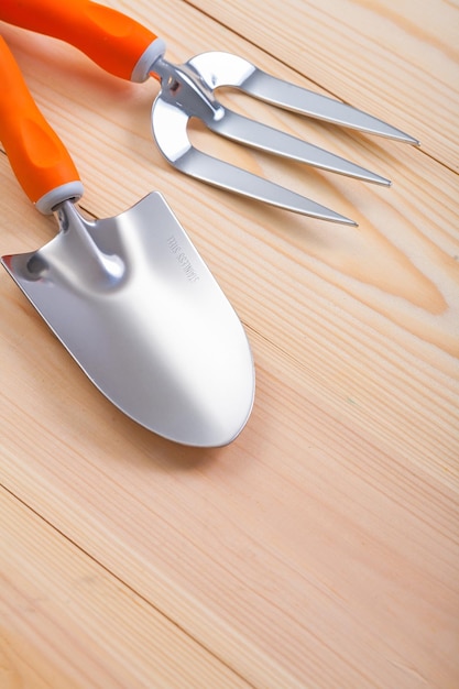 Agriculture hand tools spade and fork on wooden boards