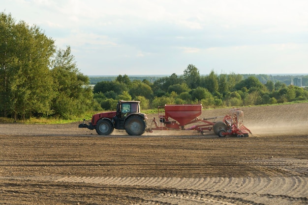 Agriculture tillage farm field with tractor cultivation of land and soil high quality photo