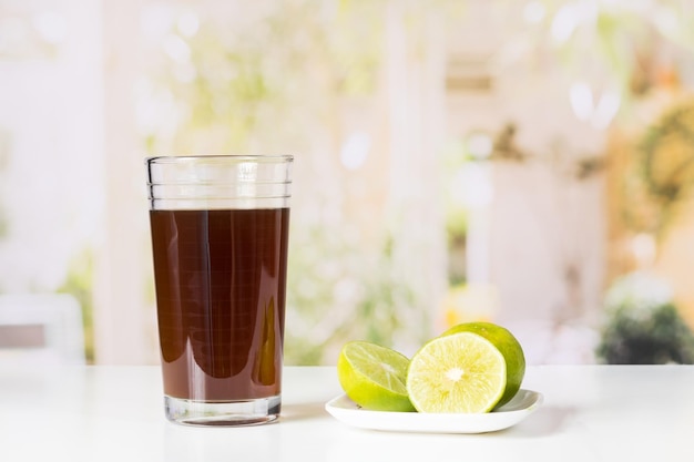 Agua de panela and lemon or sugar cane sweets and lemon in the kitchen typical food of Colombia