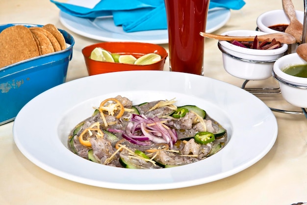 Aguachile with shrimp, onion, cucumbers, fresh chilies and lemon, typical Mexican dish, food