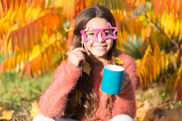 Aint it funny I love smell of autumn leaves in morning Happy little child hold coffee cup on autumn morning Small girl drink morning coffee or tea Good morning fun