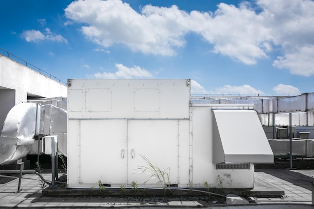 Air compressor machine part of air conditioner system on roof deck with sky background