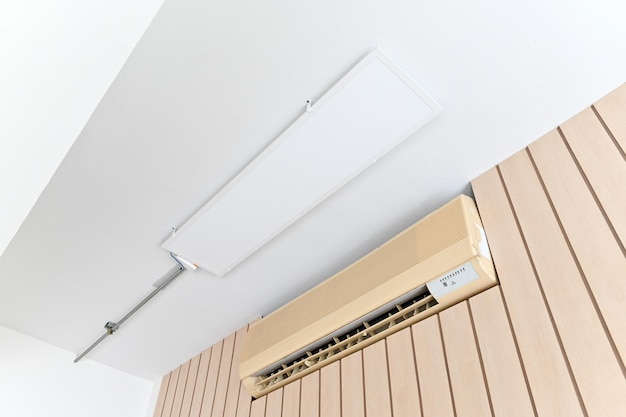 Air conditioner on brown wall room interior background