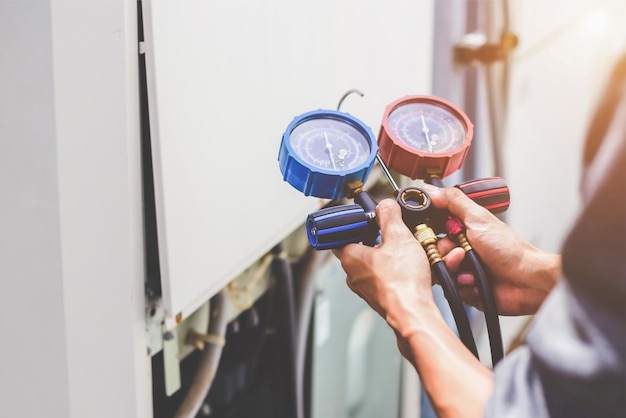 Air conditioner technician checks the operation of industrial air conditioners.