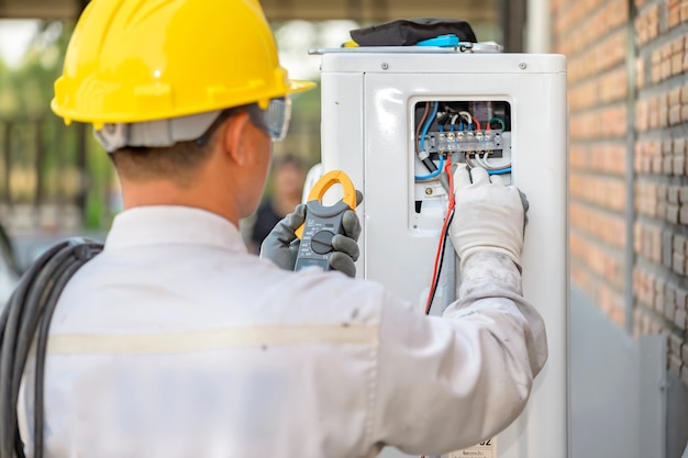 The air conditioner technician is checking the air compressor system