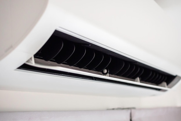 Air conditioner on white wall room interior background