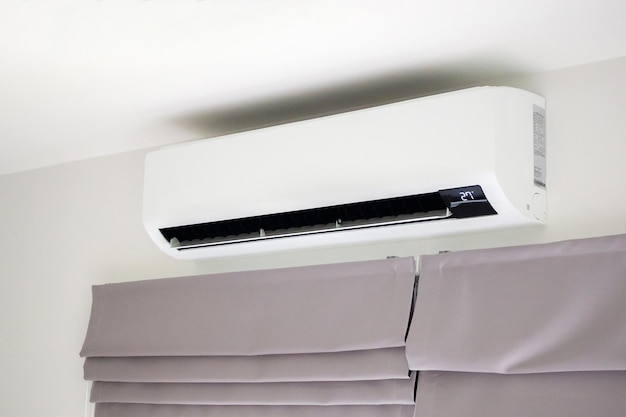 Air conditioner on white wall room interior background