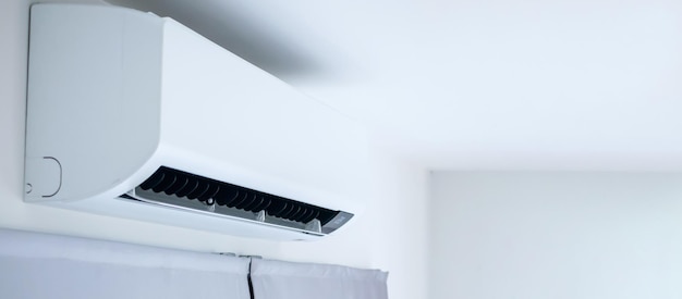 Air conditioner on white wall room interior background