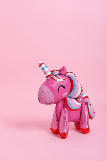 Air inflatable unicorn on a pink background