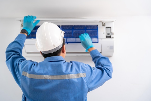 Air technician service cleaning air conditioner indoors Service concept of an air conditioner technician